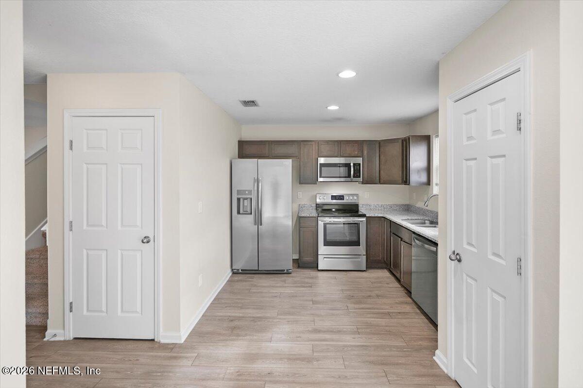 3094 Jennings Road Jacksonville, FL 32218 - Photo 7 of 33 a kitchen with stainless steel appliances granite countertop a refrigerator and a sink