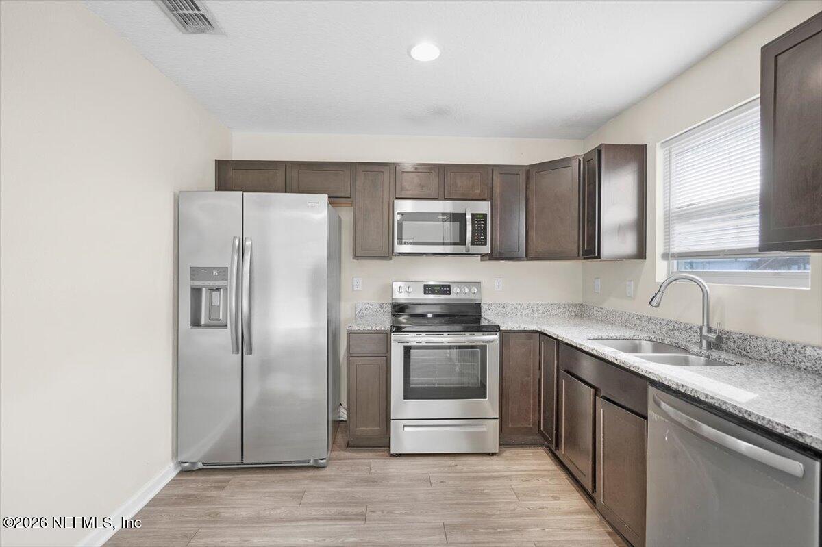 3094 Jennings Road Jacksonville, FL 32218 - Photo 8 of 33 a kitchen with stainless steel appliances granite countertop a refrigerator stove and sink