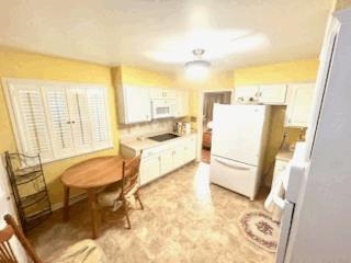 2438 Smith Ridge Road Memphis, TN 38127 - Photo 3 of 4 Kitchen featuring white appliances and white cabinets