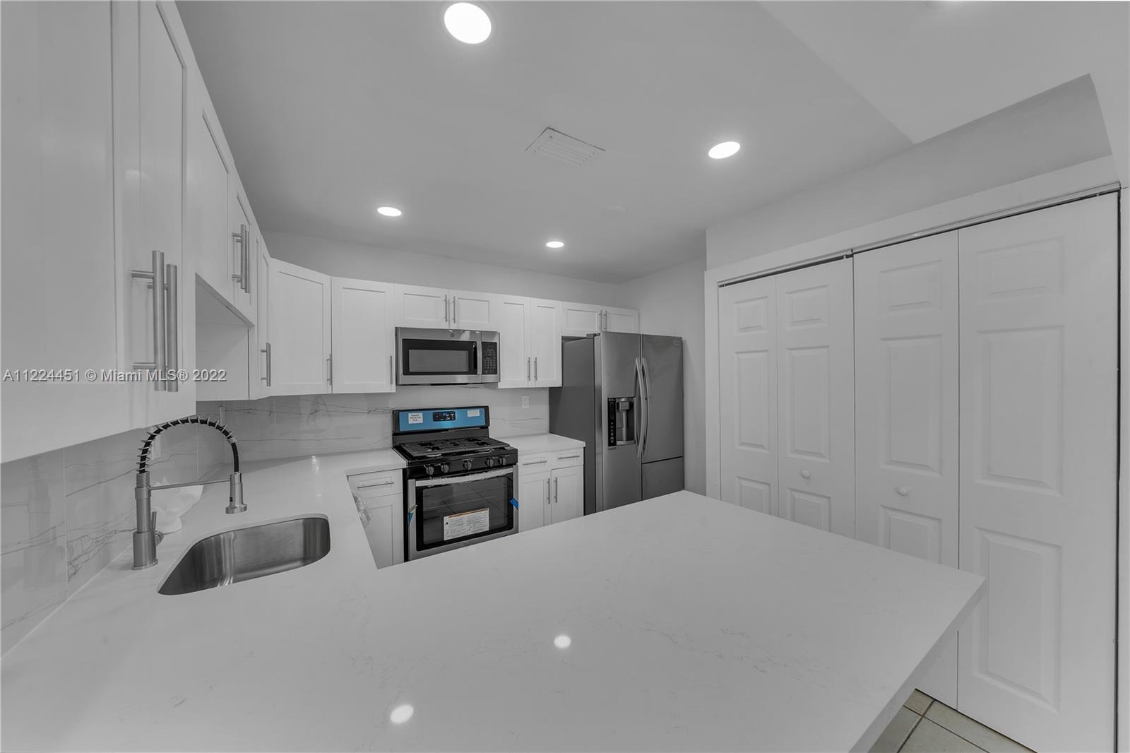 6211 Southwest 116th Place, Unit C22 Miami, FL 33173 - Photo 11 of 32 a kitchen with stainless steel appliances a refrigerator and a sink