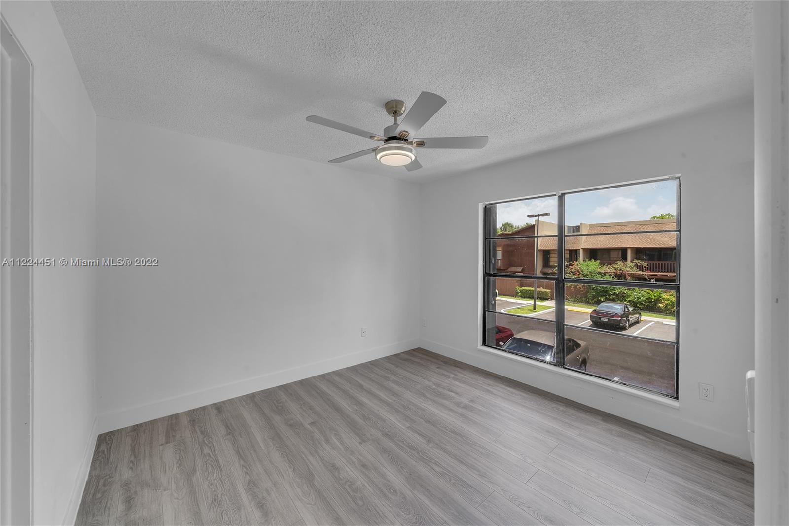 6211 Southwest 116th Place, Unit C22 Miami, FL 33173 - Photo 13 of 32 wooden floor in an empty room with a window
