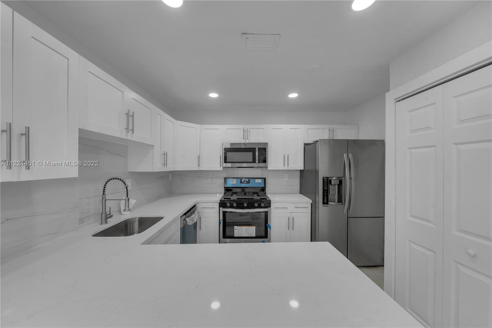 6211 Southwest 116th Place, Unit C22 Miami, FL 33173 - Photo 2 of 32 a kitchen with stainless steel appliances a refrigerator and a sink