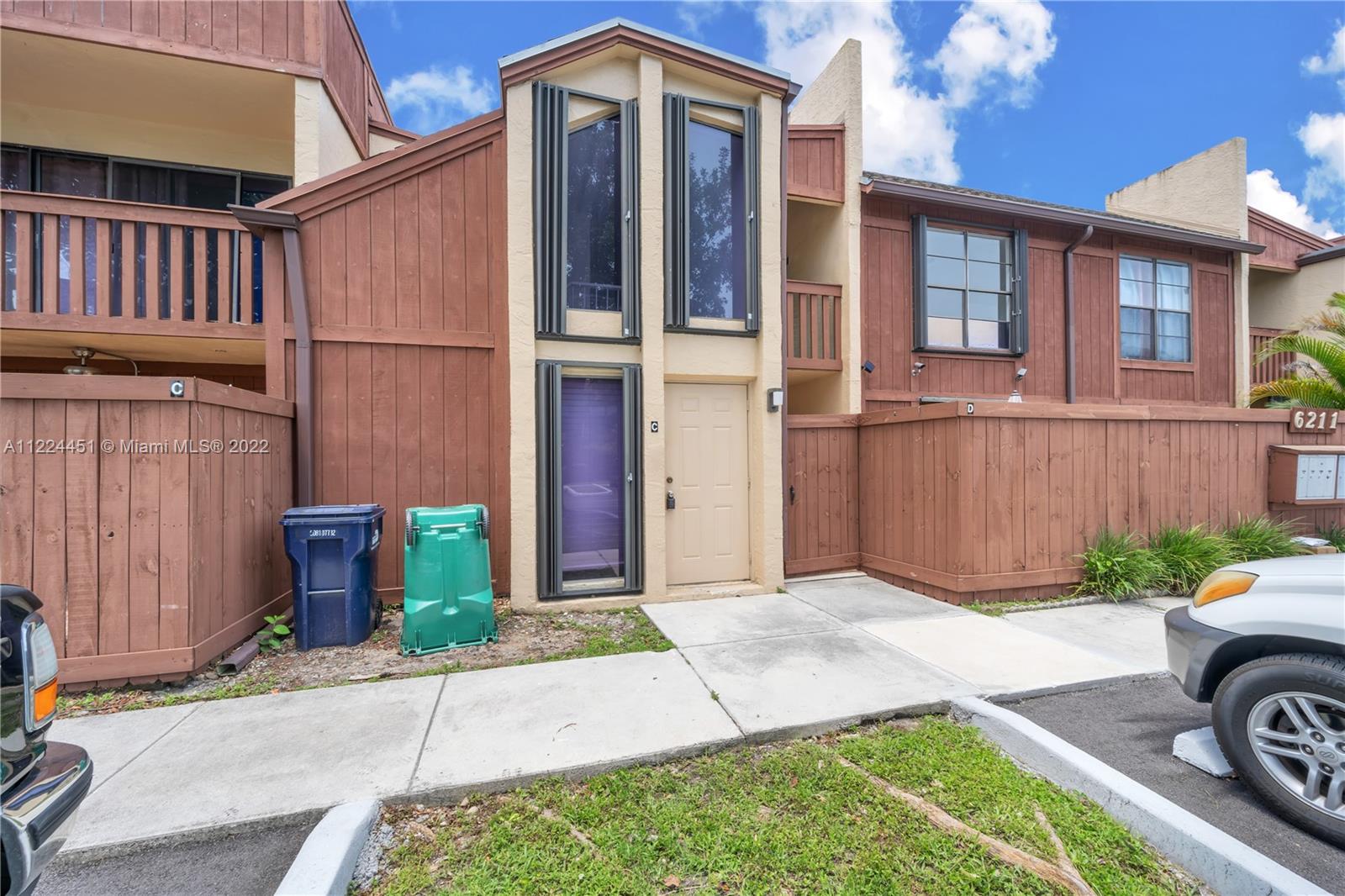6211 Southwest 116th Place, Unit C22 Miami, FL 33173 - Photo 26 of 32 a front view of a house with garden