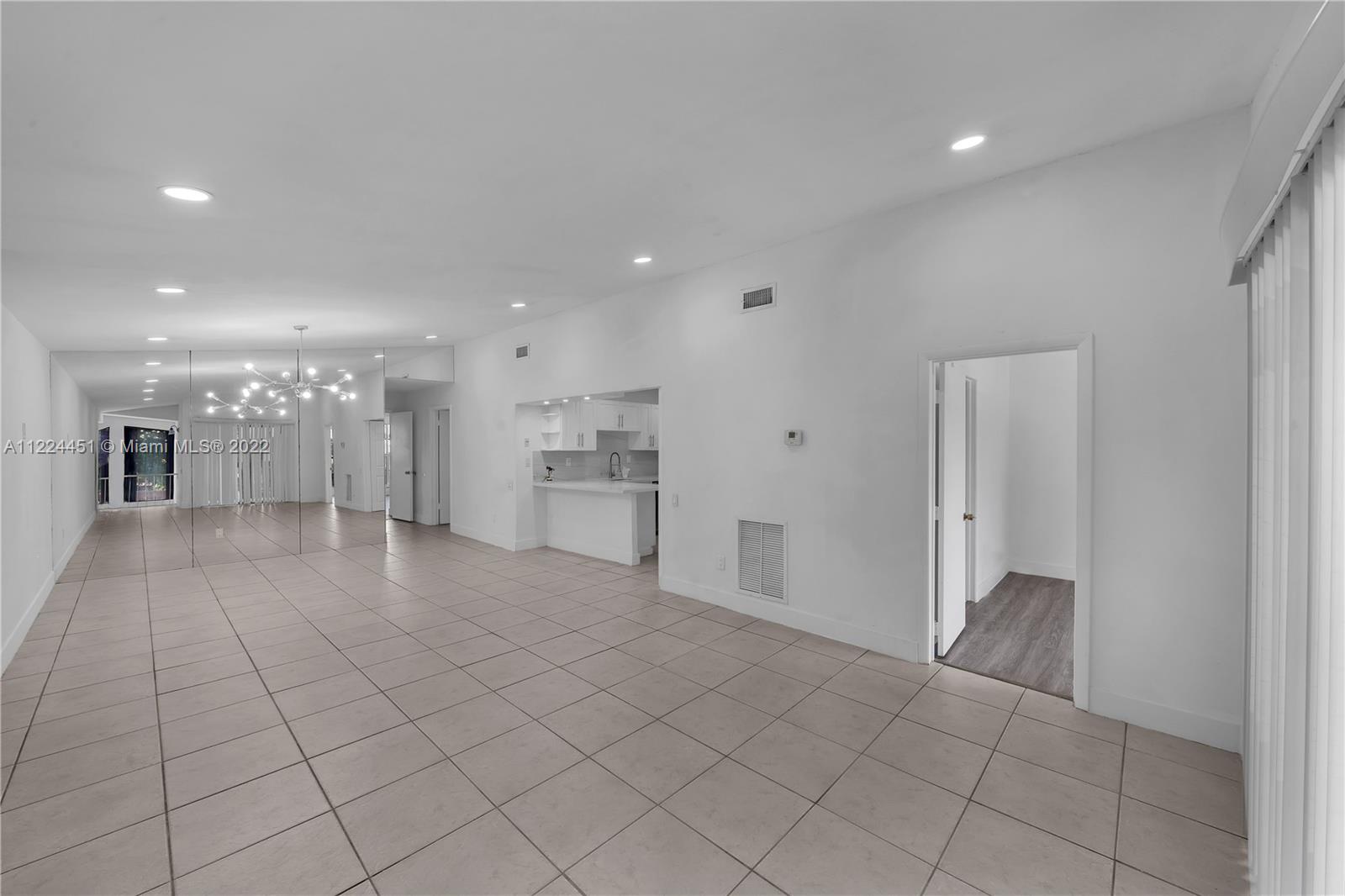 6211 Southwest 116th Place, Unit C22 Miami, FL 33173 - Photo 3 of 32 a large white kitchen with a sink and a refrigerator
