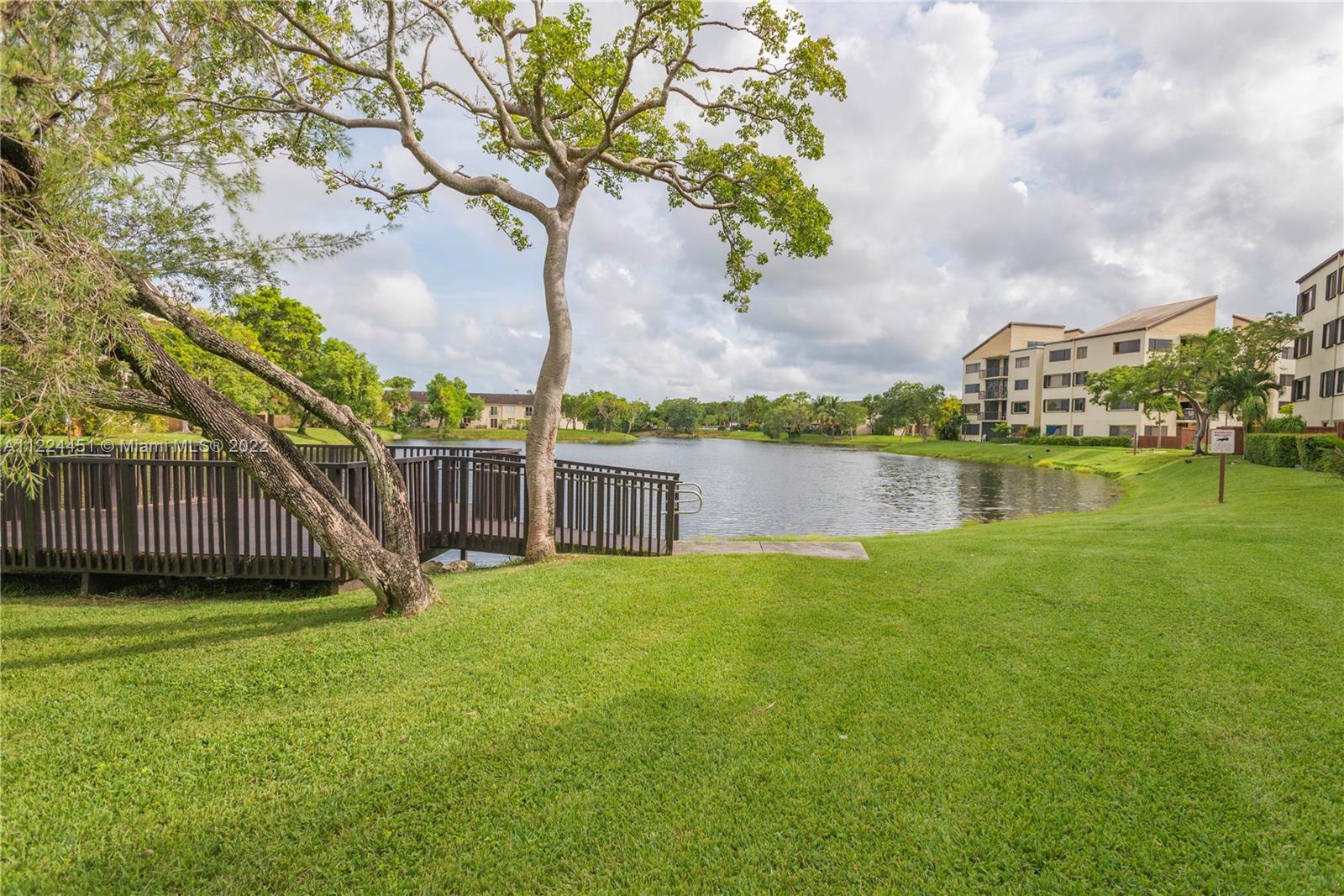 6211 Southwest 116th Place, Unit C22 Miami, FL 33173 - Photo 32 of 32 a view of a house with a yard and a large tree