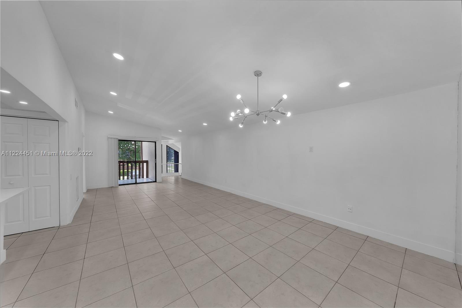 6211 Southwest 116th Place, Unit C22 Miami, FL 33173 - Photo 4 of 32 a view of a hallway with chandelier