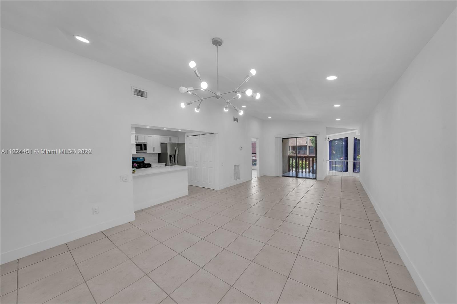 6211 Southwest 116th Place, Unit C22 Miami, FL 33173 - Photo 5 of 32 a view of a kitchen with a sink and a refrigerator