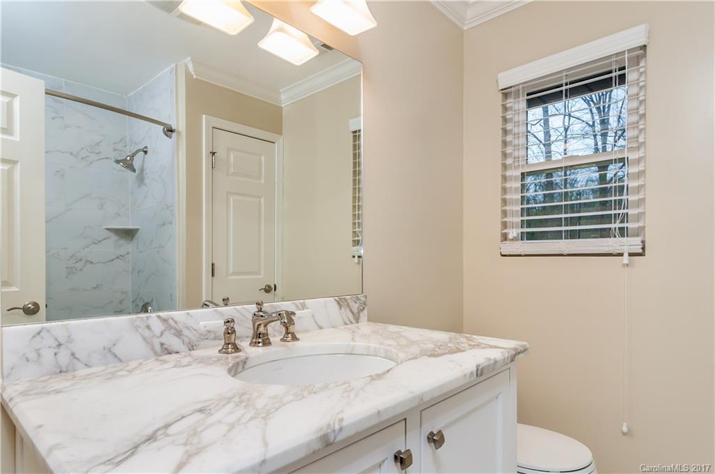3936 Tilley Morris Road Matthews, NC 28105 - Photo 11 of 24 a bathroom with a granite countertop sink and a mirror