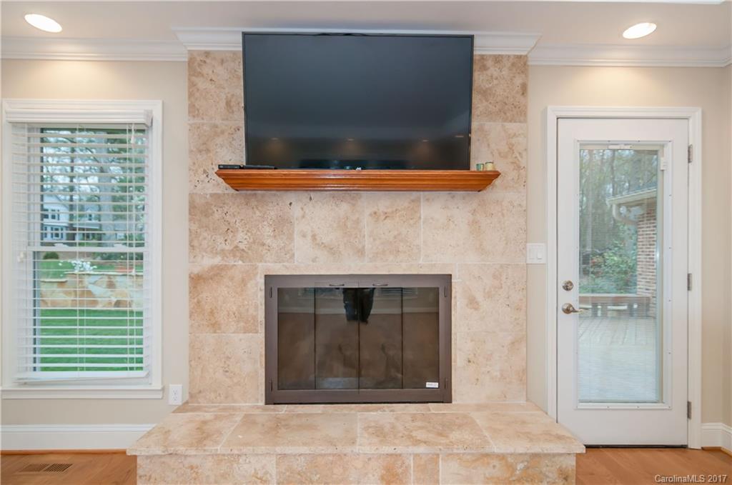 3936 Tilley Morris Road Matthews, NC 28105 - Photo 3 of 24 a living room with a fireplace and a flat screen tv