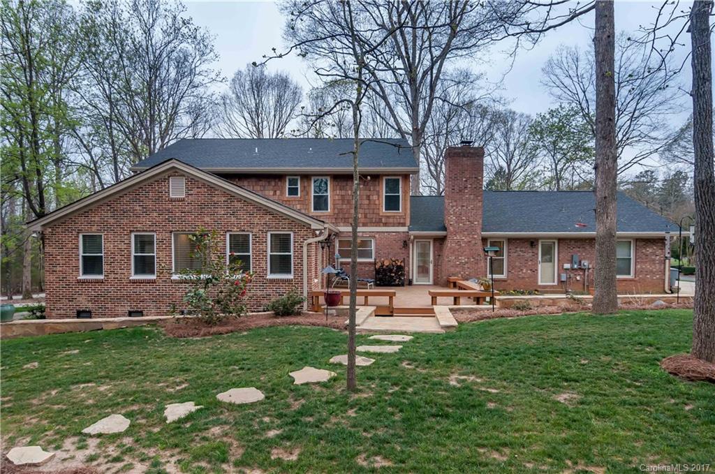 3936 Tilley Morris Road Matthews, NC 28105 - Photo 23 of 24 a front view of a house with a garden and trees