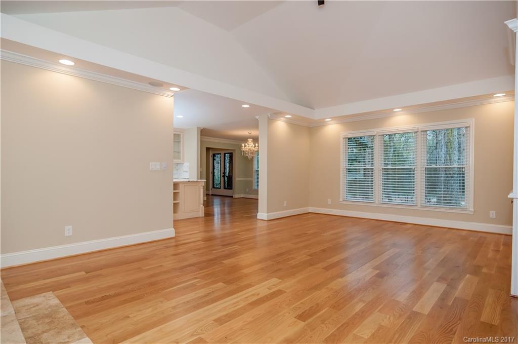3936 Tilley Morris Road Matthews, NC 28105 - Photo 4 of 24 a view of an empty room with wooden floor and a window