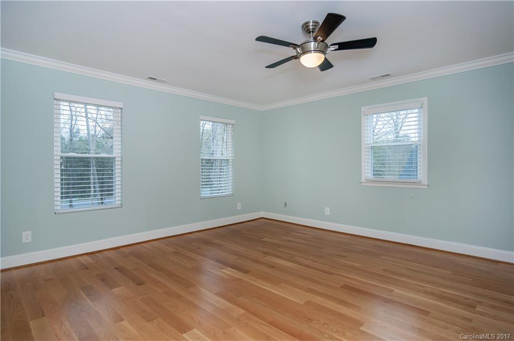 3936 Tilley Morris Road Matthews, NC 28105 - Photo 6 of 24 an empty room with wooden floor and windows