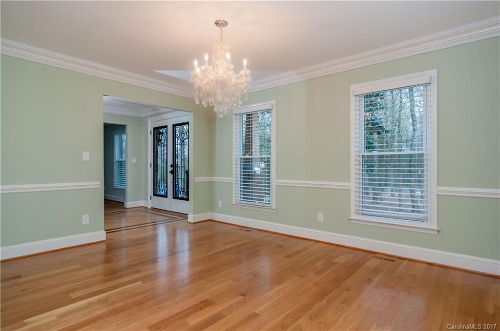 3936 Tilley Morris Road Matthews, NC 28105 - Photo 7 of 24 a view of an empty room with wooden floor and a window