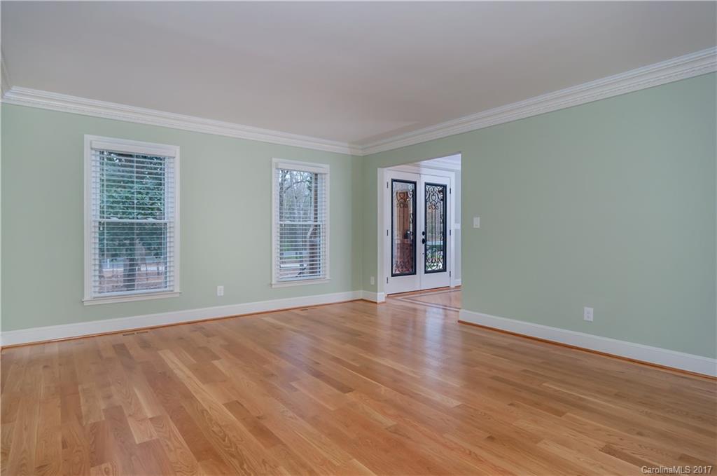 3936 Tilley Morris Road Matthews, NC 28105 - Photo 8 of 24 a view of an empty room with wooden floor and windows