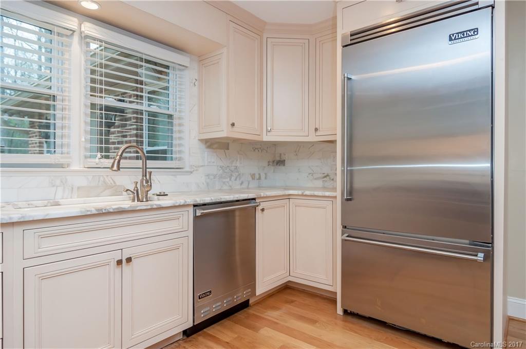 3936 Tilley Morris Road Matthews, NC 28105 - Photo 10 of 24 a kitchen with white cabinets and a refrigerator