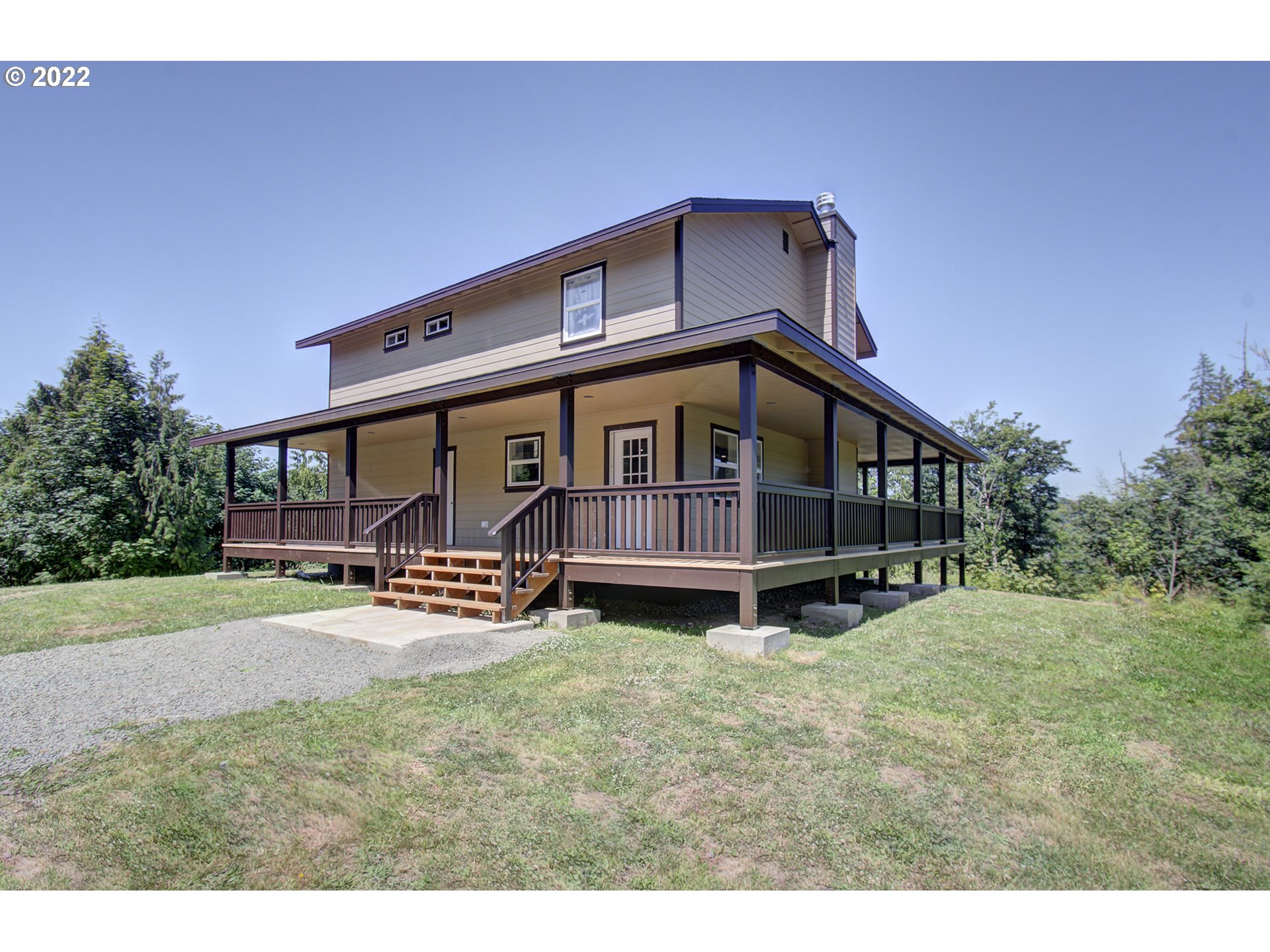 70446 Forest Park Road Rainier, OR 97048 - Photo 1 of 32 a backyard of a house with table and chairs