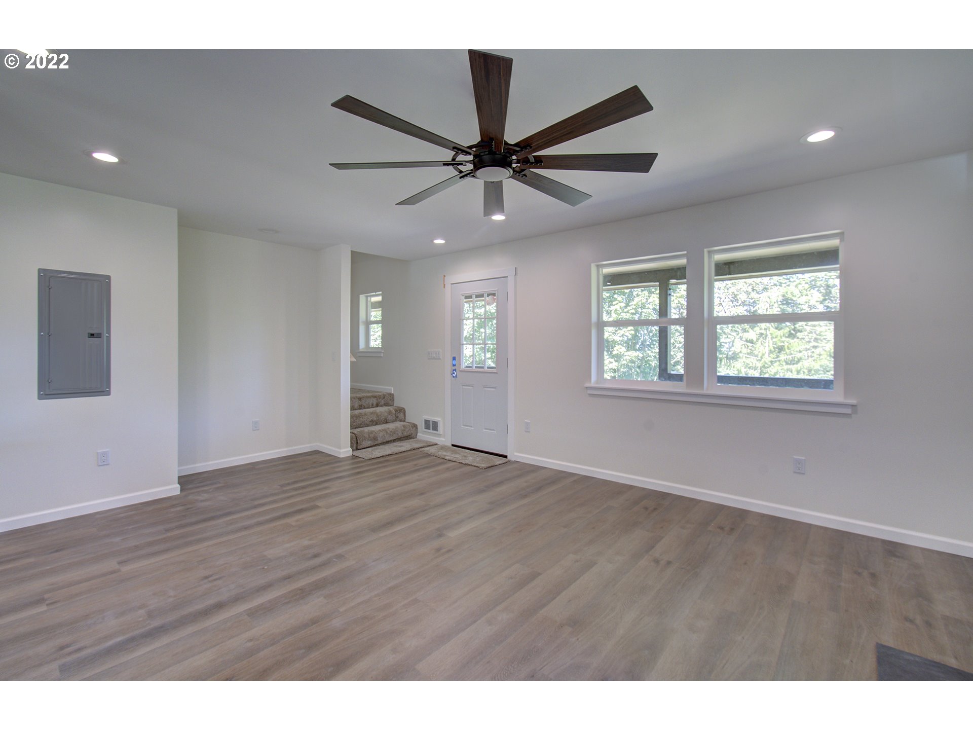 70446 Forest Park Road Rainier, OR 97048 - Photo 3 of 32 a view of an empty room with a window and wooden floor