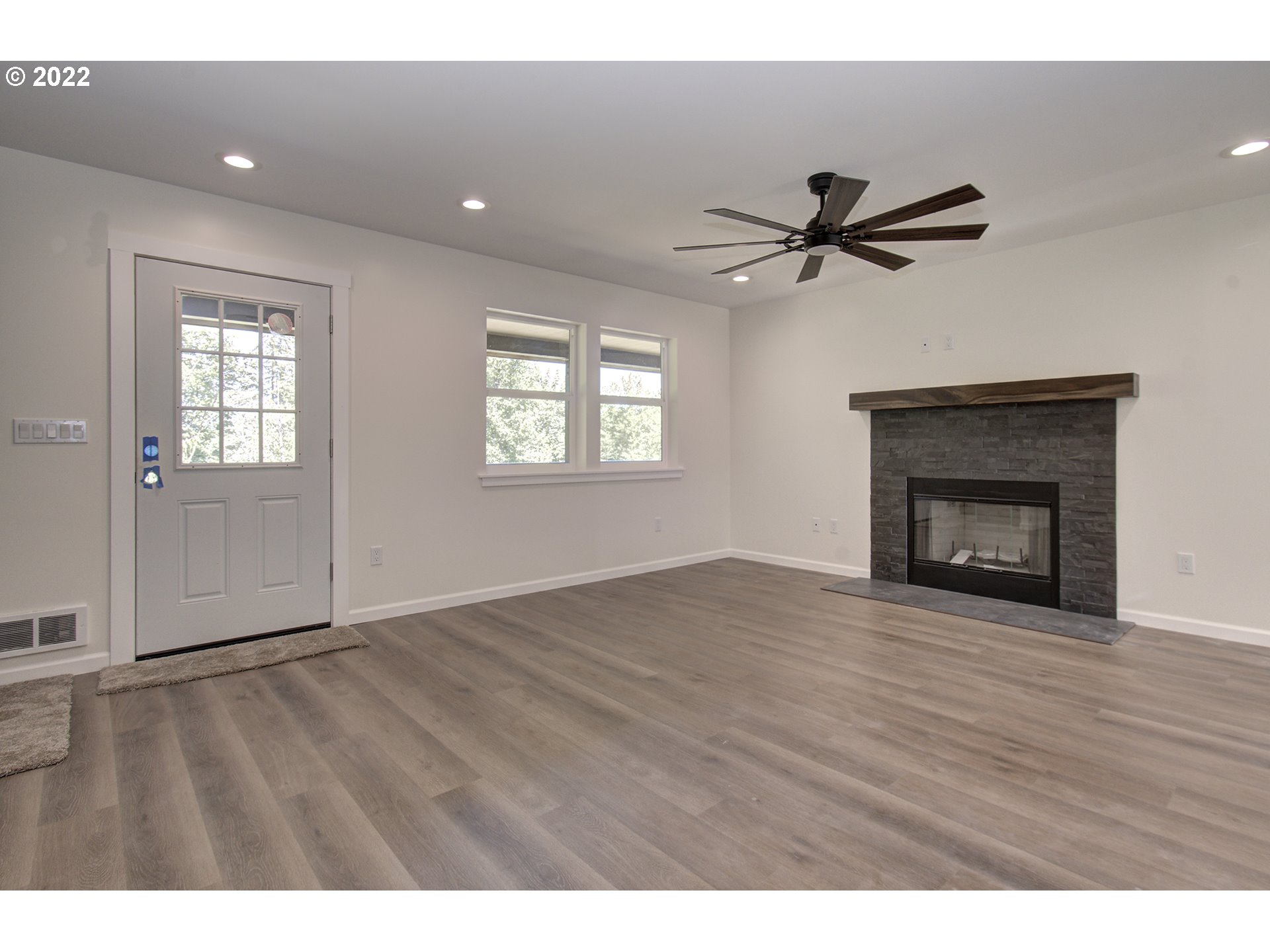 70446 Forest Park Road Rainier, OR 97048 - Photo 4 of 32 a view of empty room with wooden floor and fan