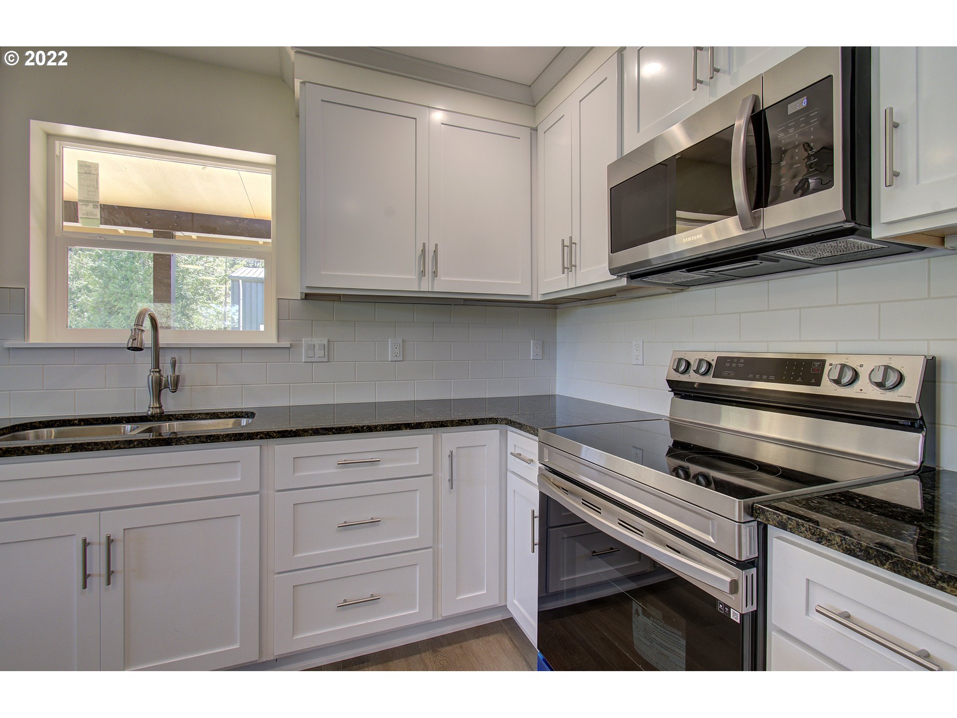 70446 Forest Park Road Rainier, OR 97048 - Photo 10 of 32 a kitchen with stainless steel appliances granite countertop white cabinets and a sink