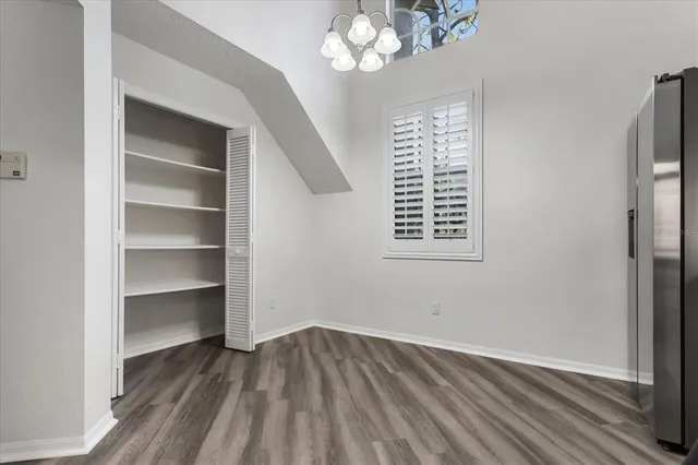 a kitchen with stainless steel appliances granite countertop a refrigerator stove a sink and dishwasher with wooden floor