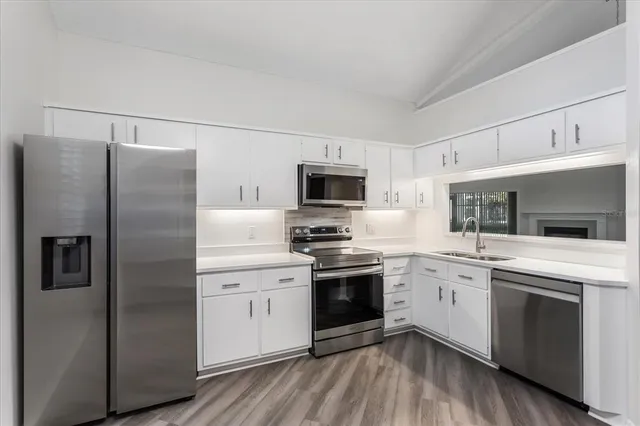 a view of a kitchen with electric appliances