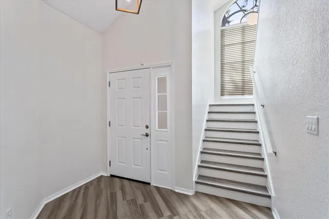 a view of a livingroom with wooden floor and white walls