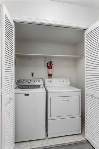 a bathroom with a toilet a sink a mirror and a window