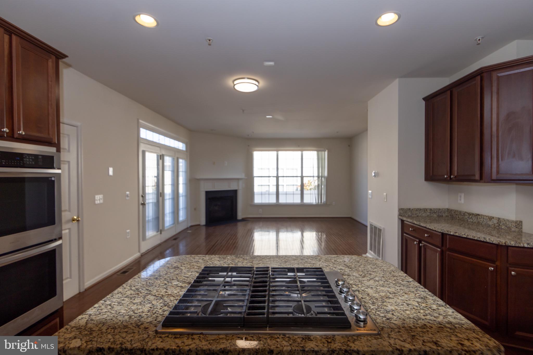 9814 Traver Street Bowie, MD 20721 - Photo 13 of 75 a view of a kitchen with granite countertop stainless steel appliances stove top oven and cabinets