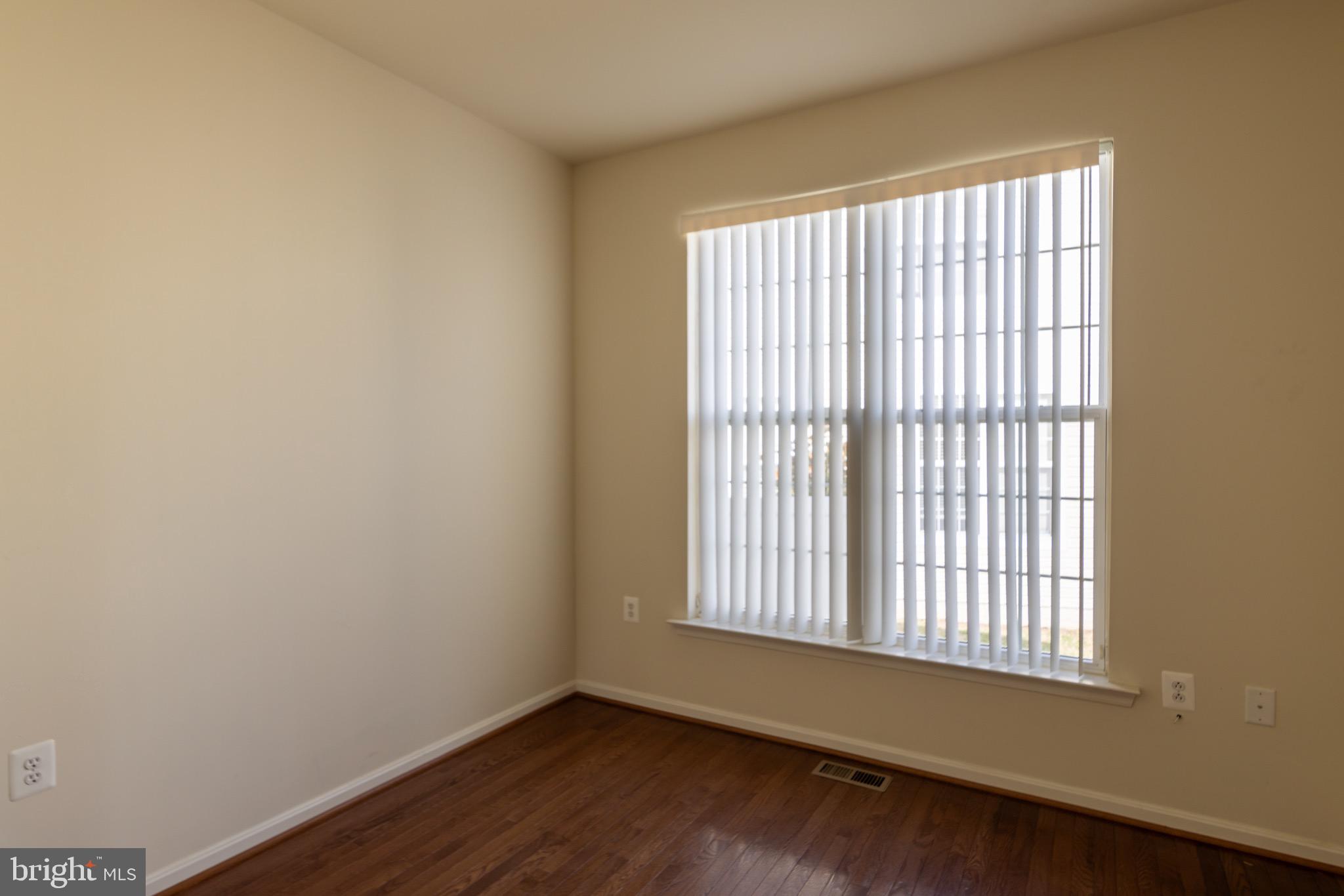 9814 Traver Street Bowie, MD 20721 - Photo 23 of 75 a view of an empty room with wooden floor and a window