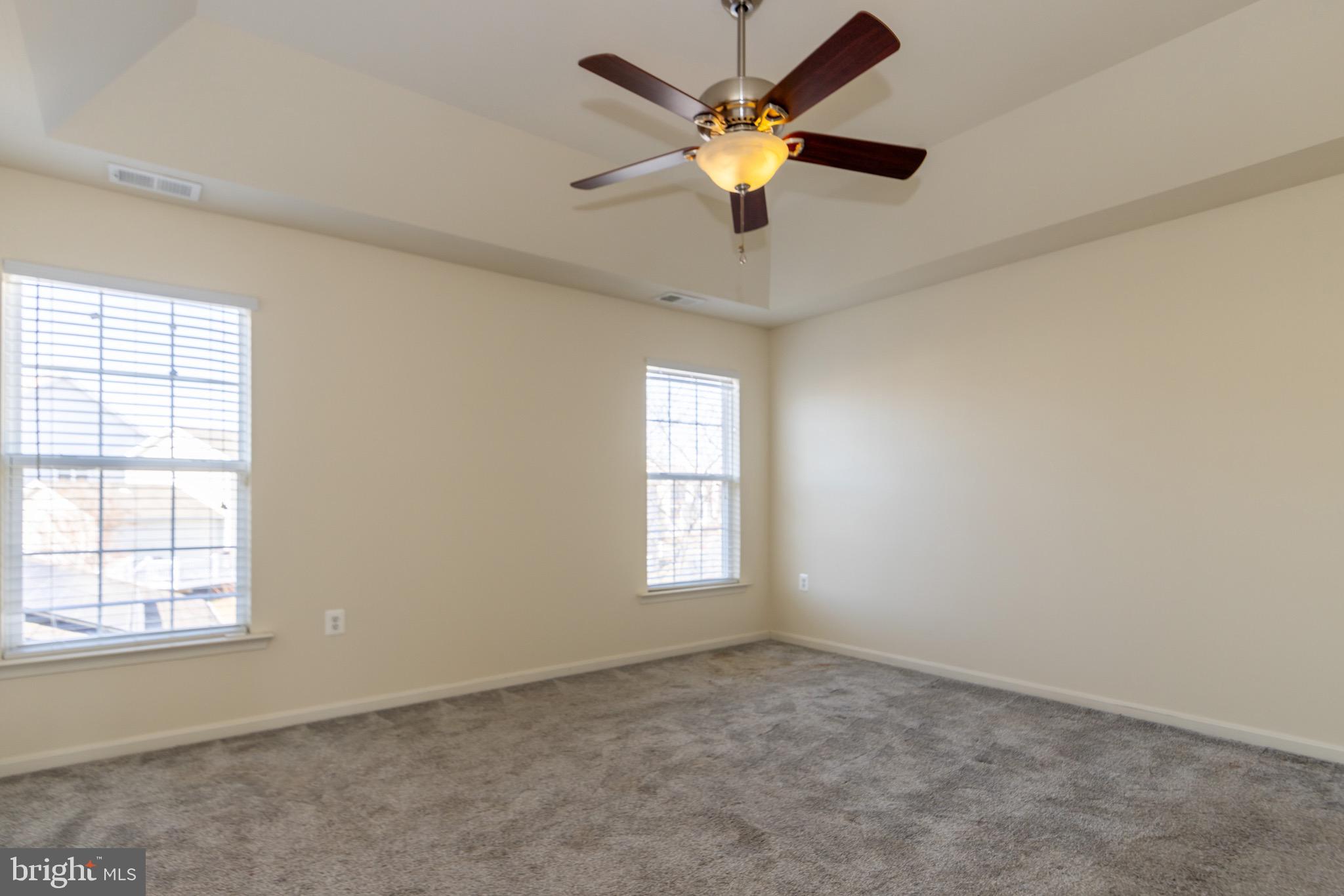 9814 Traver Street Bowie, MD 20721 - Photo 24 of 75 an empty room with a window and a ceiling fan