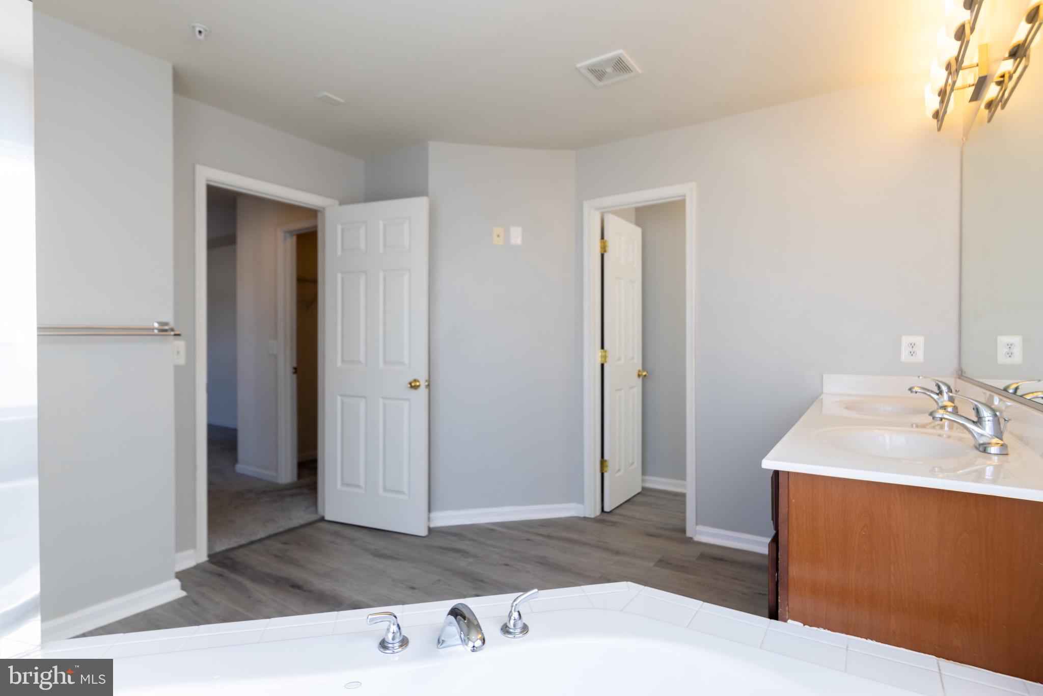 9814 Traver Street Bowie, MD 20721 - Photo 31 of 75 a bathroom with a sink a mirror and a shower