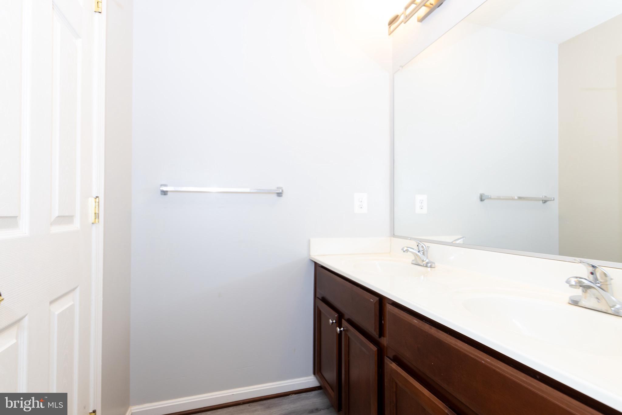 9814 Traver Street Bowie, MD 20721 - Photo 48 of 75 a bathroom with a sink and a mirror