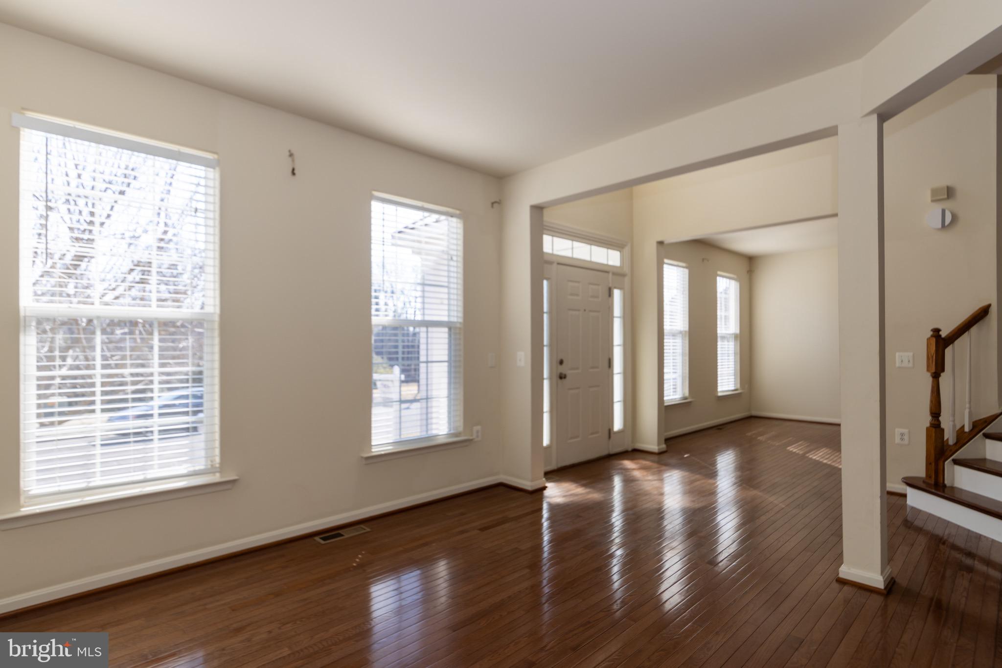 9814 Traver Street Bowie, MD 20721 - Photo 5 of 75 a view of an empty room with wooden floor and a window