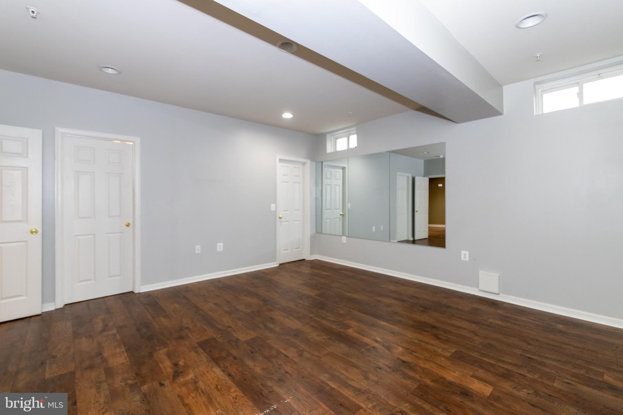 9814 Traver Street Bowie, MD 20721 - Photo 58 of 75 a view of an empty room with wooden floor and window