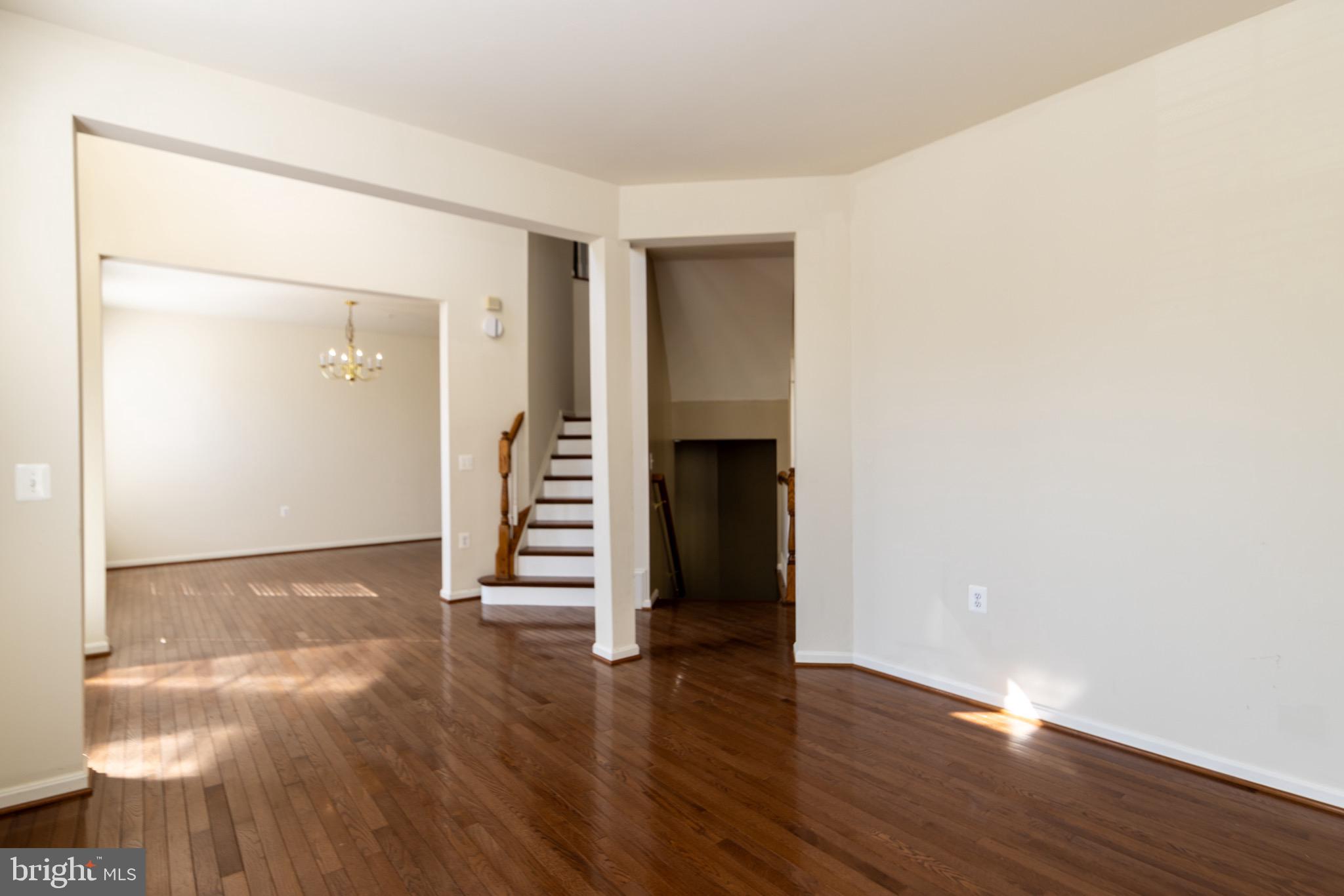 9814 Traver Street Bowie, MD 20721 - Photo 6 of 75 a view of an empty room with wooden floor and a window
