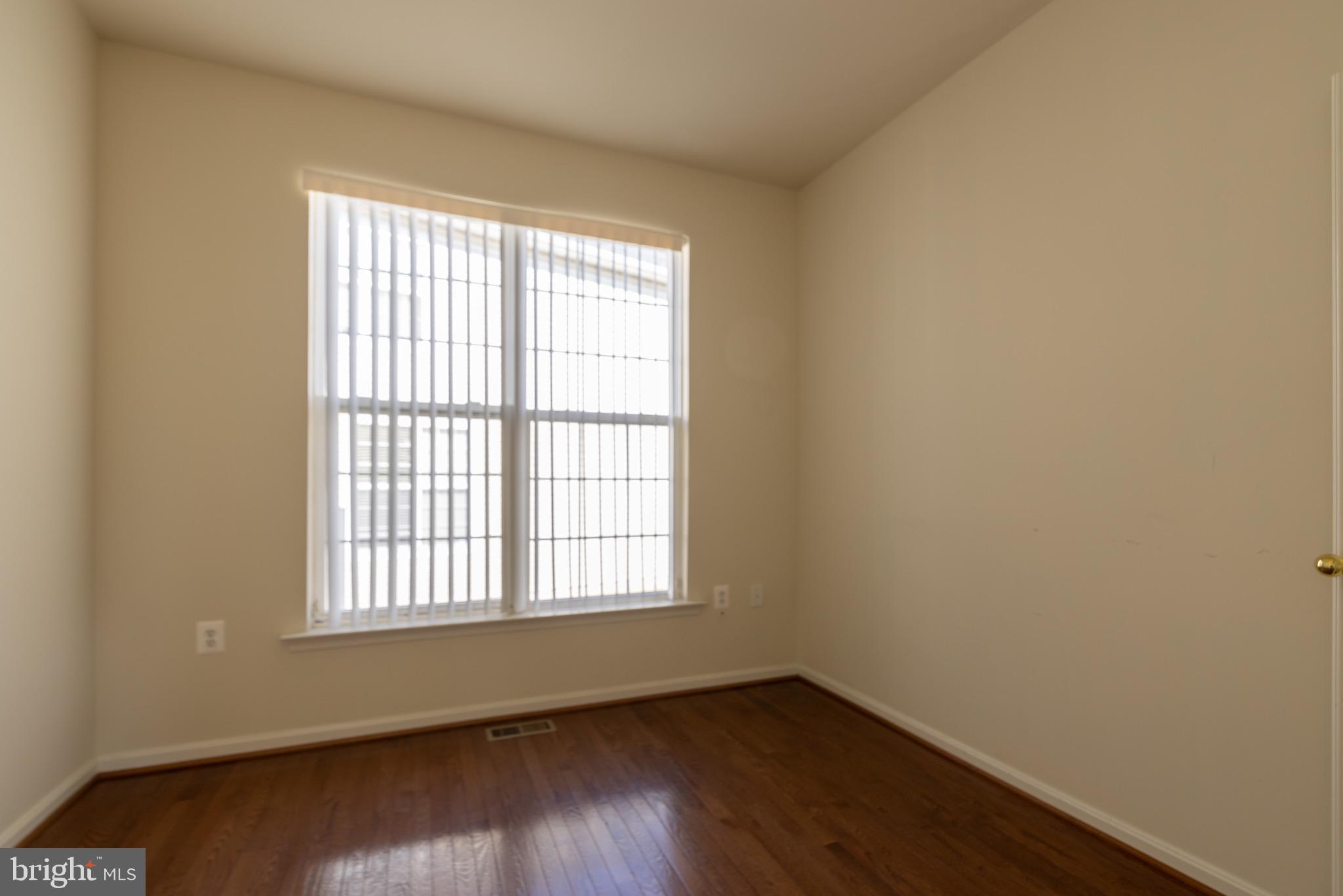 9814 Traver Street Bowie, MD 20721 - Photo 63 of 75 an empty room with wooden floor and windows