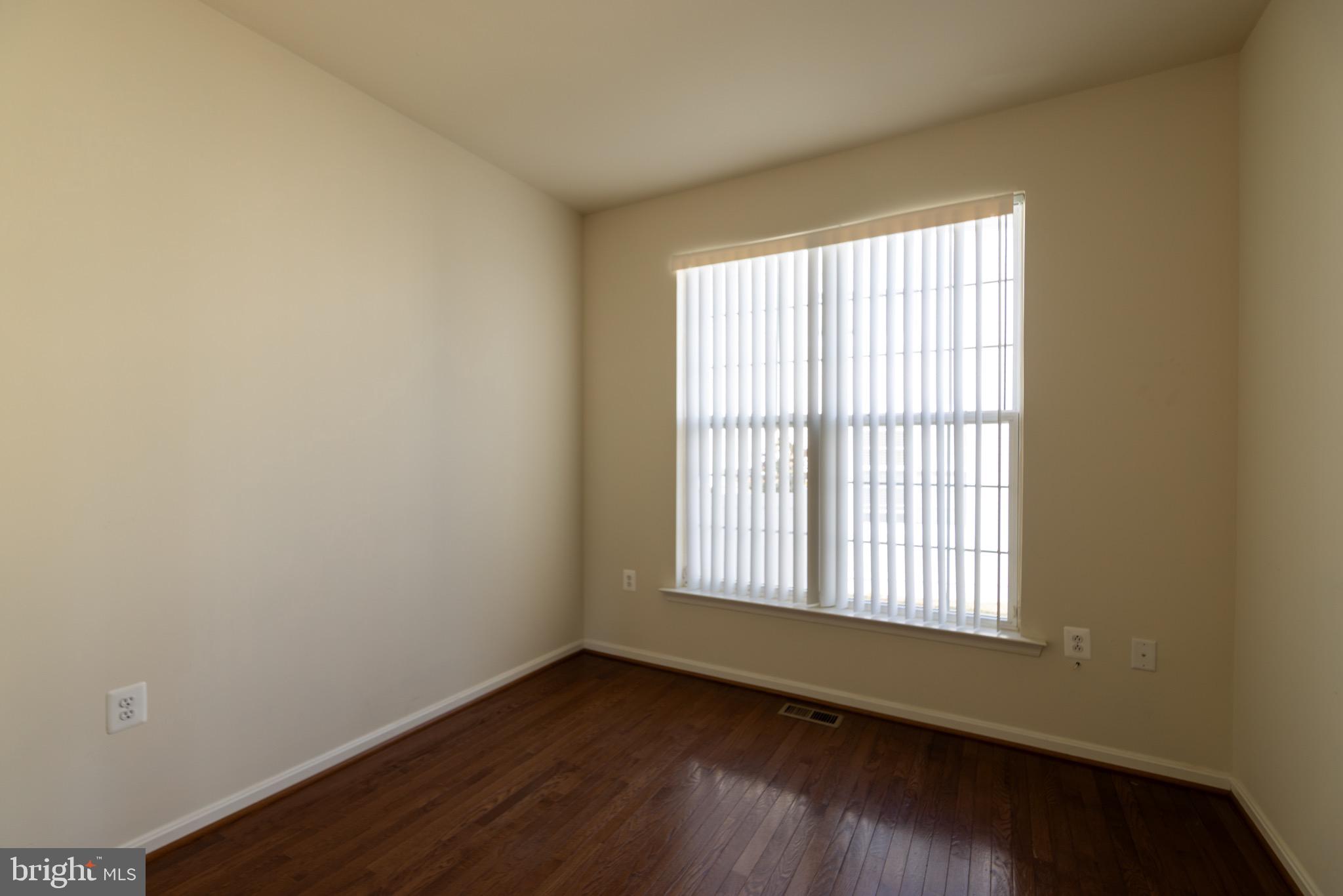 9814 Traver Street Bowie, MD 20721 - Photo 64 of 75 an empty room with wooden floor and windows