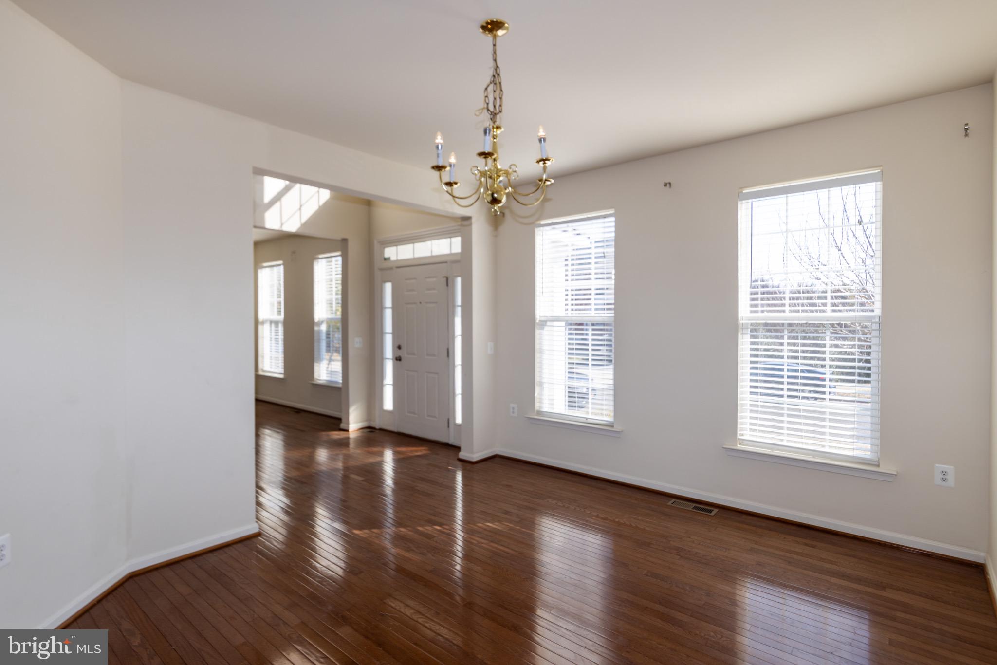 9814 Traver Street Bowie, MD 20721 - Photo 9 of 75 a view of an empty room with wooden floor and a window