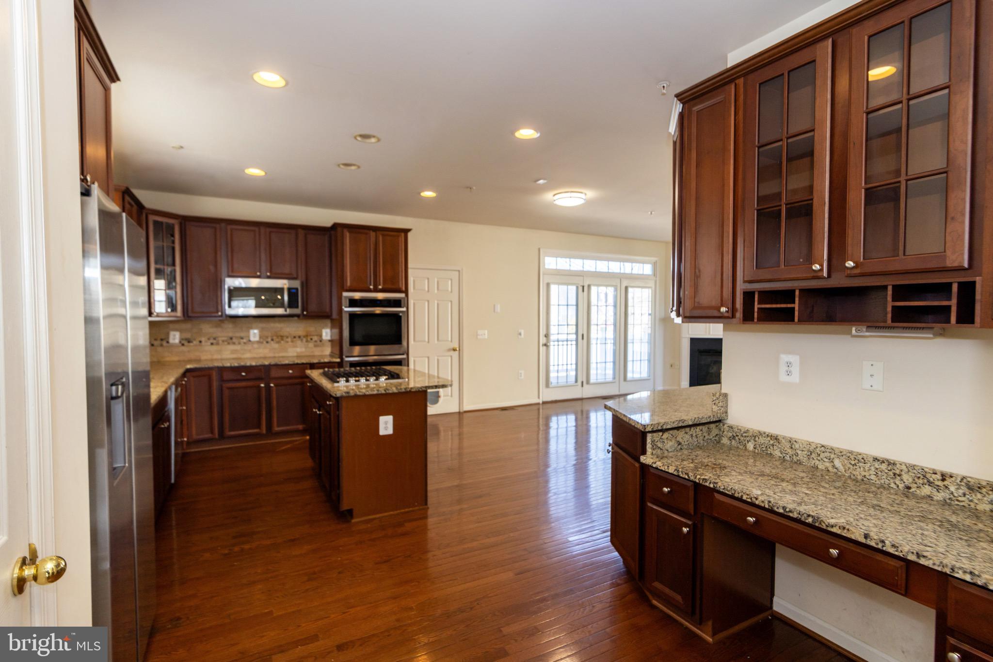 9814 Traver Street Bowie, MD 20721 - Photo 10 of 75 a kitchen with stainless steel appliances granite countertop wooden cabinets a refrigerator a stove a sink and a oven