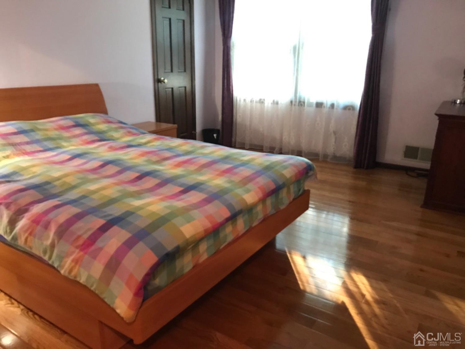 27 Fox Hill Road Edison, NJ 08820 - Photo 13 of 27 a bedroom with a bed and wooden floor