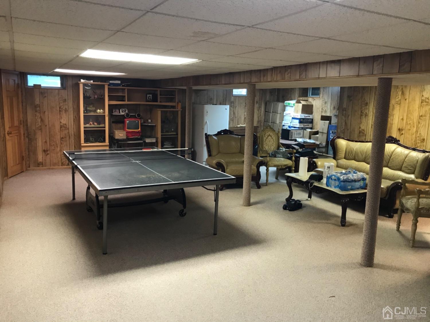 27 Fox Hill Road Edison, NJ 08820 - Photo 23 of 27 a living room with furniture a ceiling fan and a rug