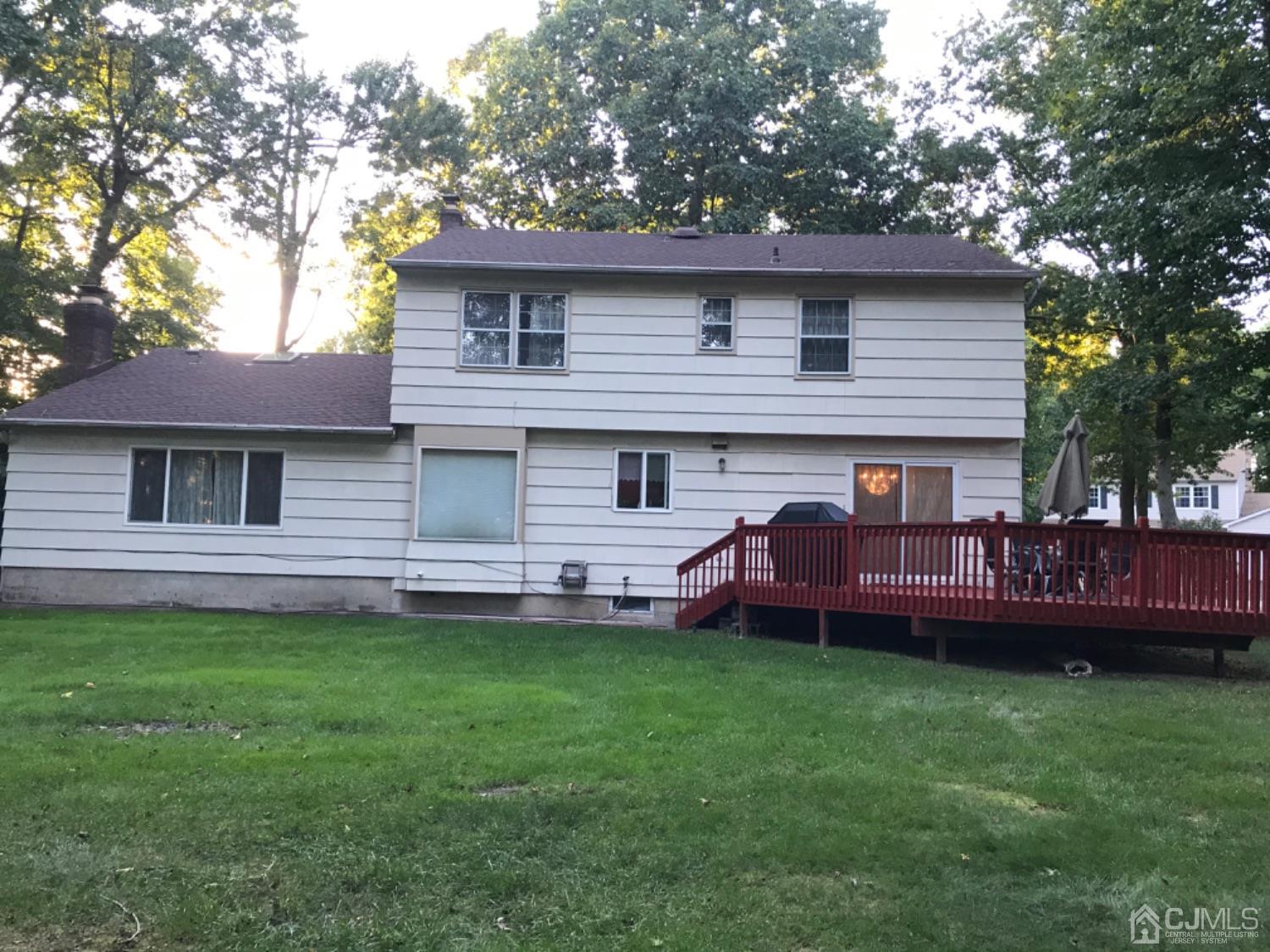 27 Fox Hill Road Edison, NJ 08820 - Photo 25 of 27 a front view of a house with a garden and deck