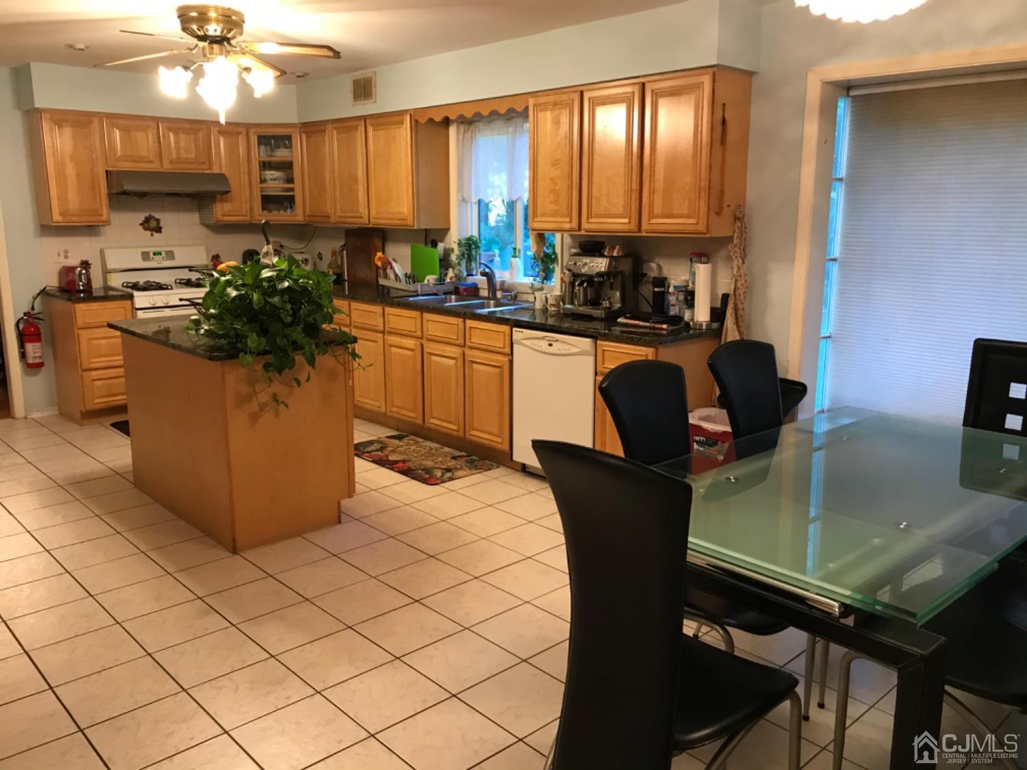 27 Fox Hill Road Edison, NJ 08820 - Photo 7 of 27 a kitchen with a table chairs sink and cabinets