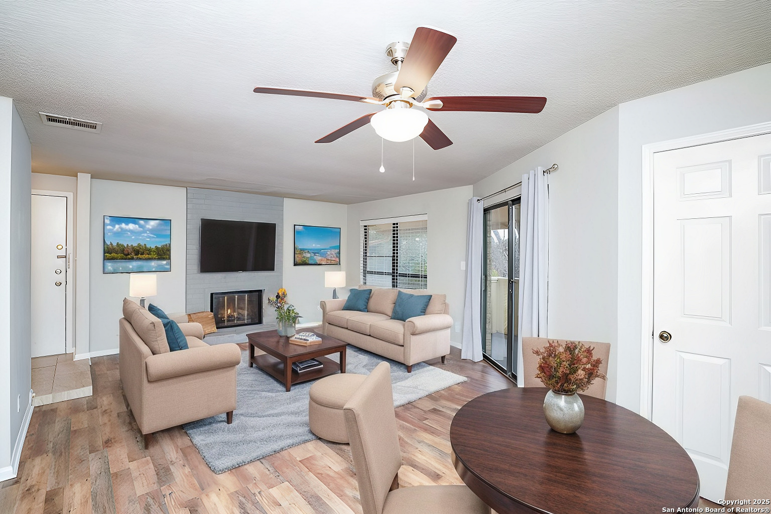 a living room with furniture and a wooden floor