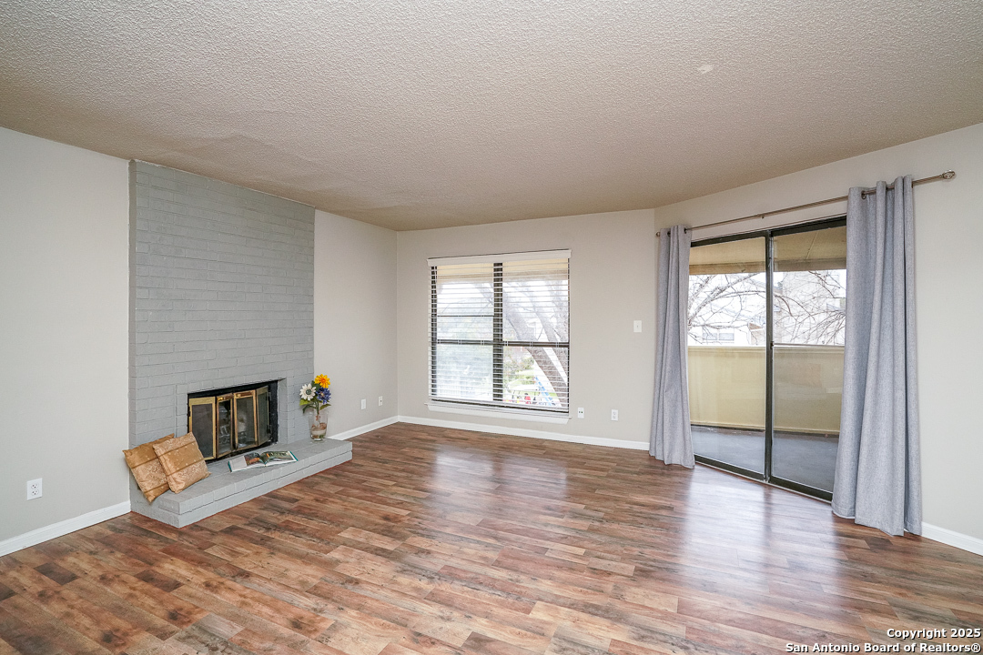 11843 Braesview, Unit 1612 San Antonio, TX 78231 - Photo 13 of 31 an empty room with wooden floor and windows