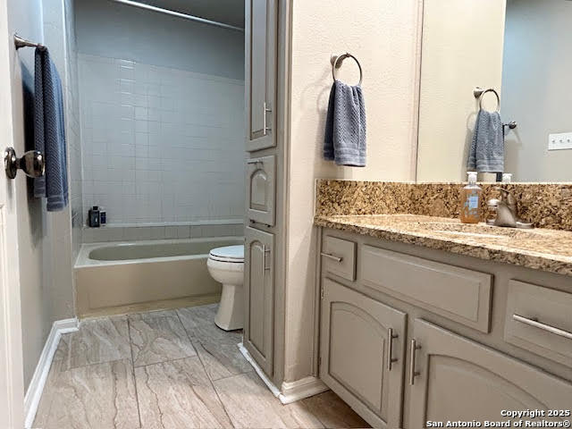 11843 Braesview, Unit 1612 San Antonio, TX 78231 - Photo 16 of 31 a bathroom with a sink and mirror with toilet
