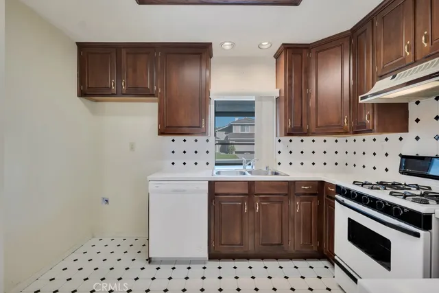 a kitchen with stainless steel appliances a stove a sink and a refrigerator
