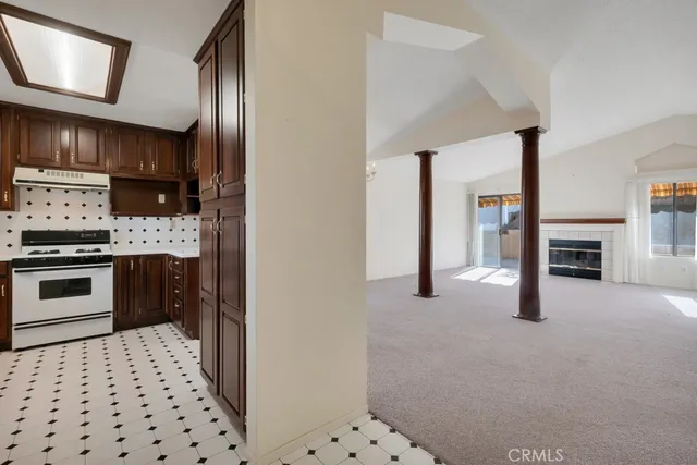 a kitchen with granite countertop a stove and a refrigerator