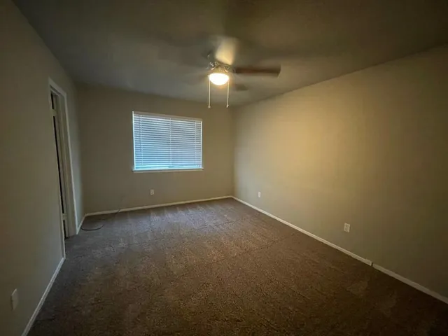 an empty room with a empty space and windows