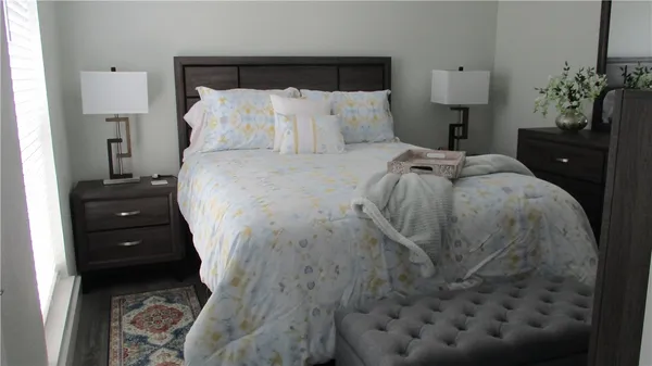 a bed room with a bed and a potted plant